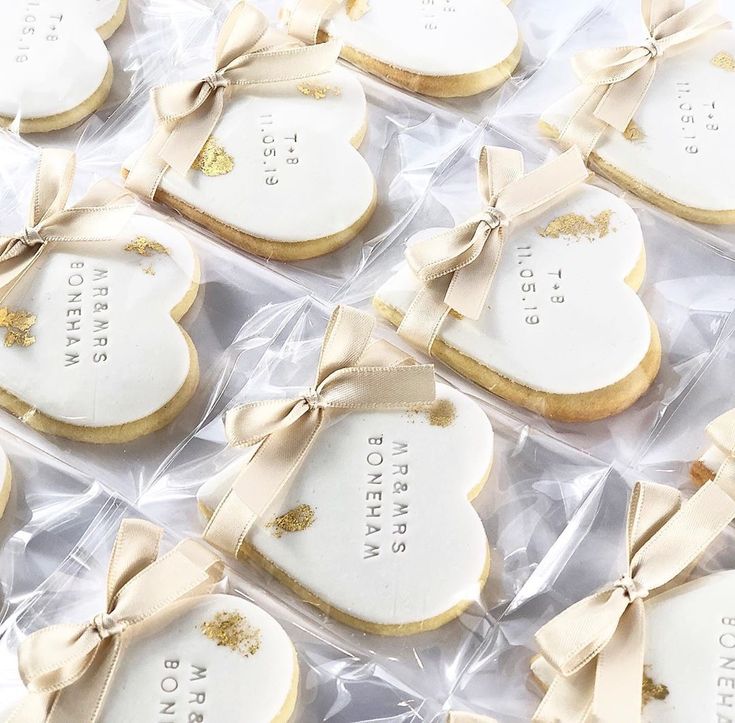 Charming Heart-Shaped Cookies with Gold Leaf and Ribbons Perfect for Celebrations.