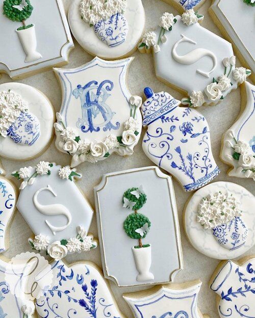 Elegant Floral and Monogram Cookie Designs in Blue and White for Special Occasions.