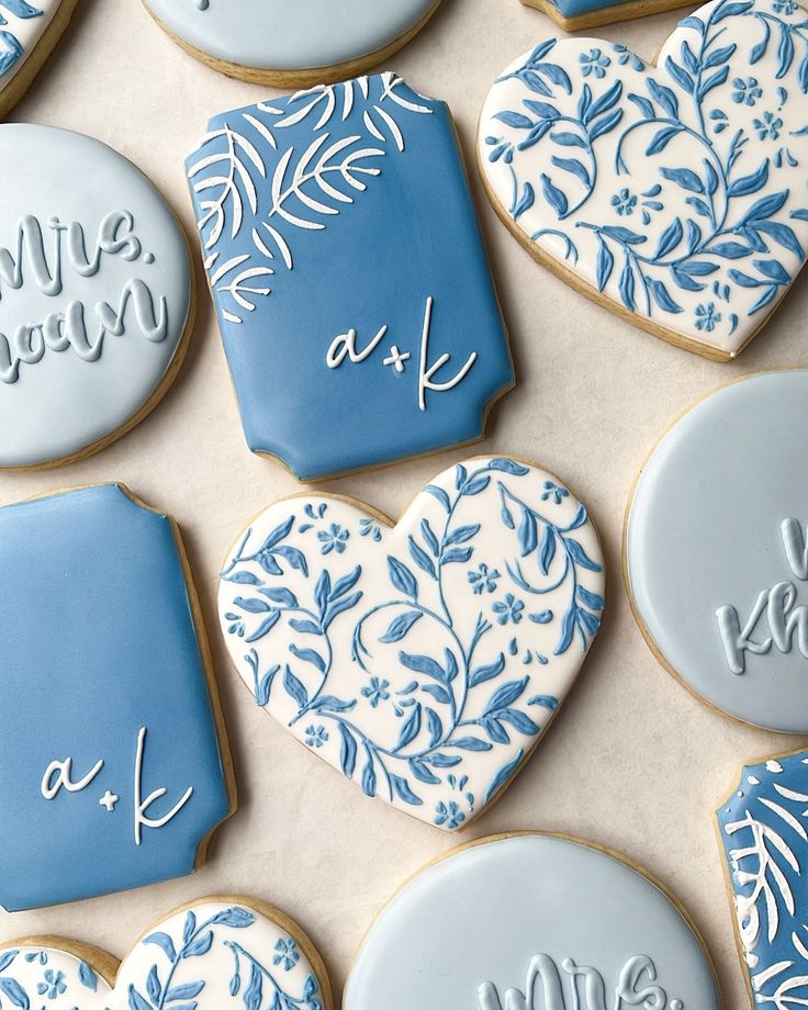 Elegant Heart-Shaped and Rectangular Cookies with Intricate Blue and White Icing for Romantic Celebrations.