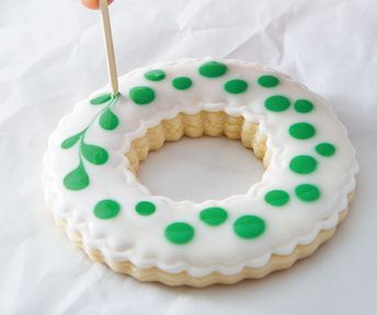 Festive Circular Cookie with Playful Green Icing Design