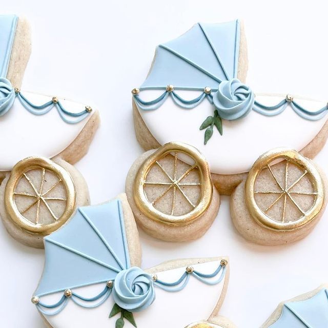 Elegant Baby Carriage Cookies: Soft Blue with Floral and Gold Accents for Special Celebrations.