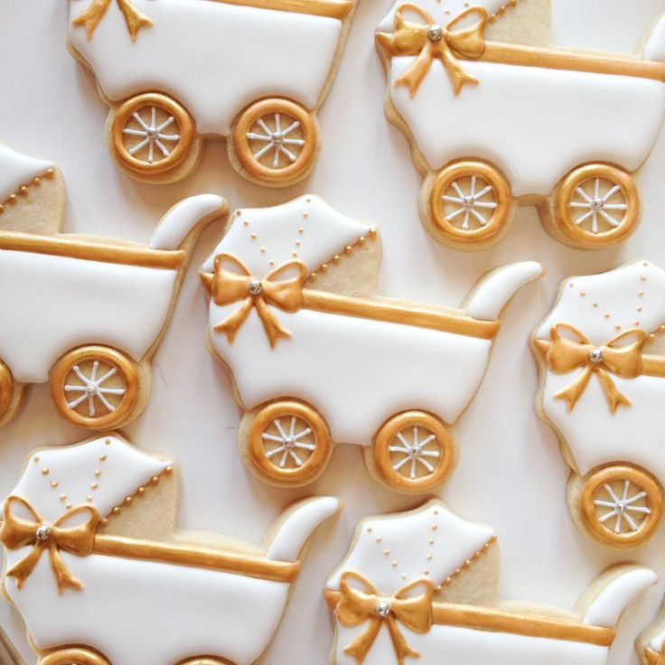 Elegant Baby Carriage Cookies: Delicate Icing and Golden Accents for Celebrations.