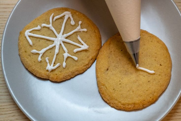 Intricate Snowflake Designs Adorning Chocolate Chip Cookies with Icing.