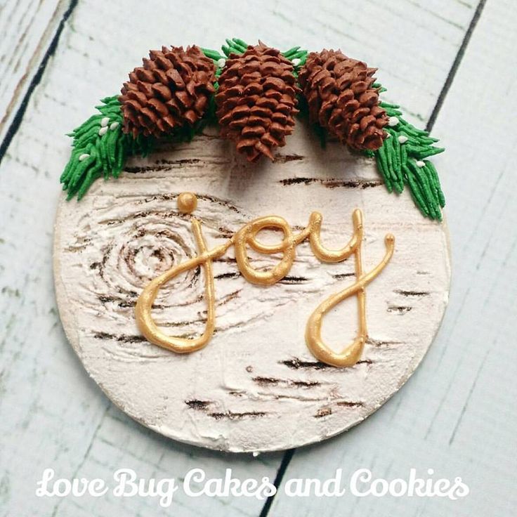 Rustic Holiday Cake Decoration with Wooden Texture, Pinecones, and Intricate Icing.