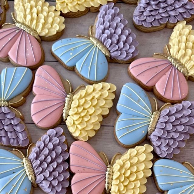 Colorful Butterfly Cookies with Intricate Icing Designs in Pastel Shades.