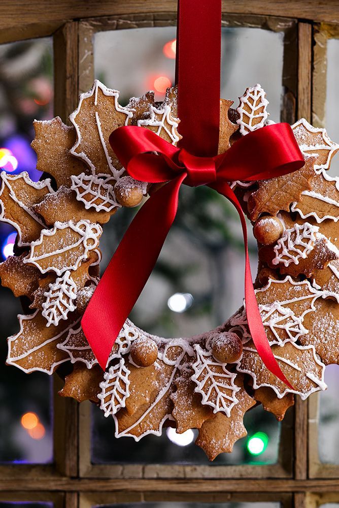 Festive Gingerbread Wreath: A Whimsical Holiday Centerpiece Decorated with Holly and Ribbon.