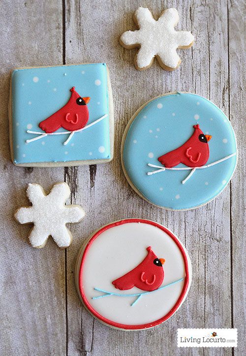 Cheerful Holiday Cookies: Bright Red Cardinals on Soft Blue Backgrounds with Delicate Icing Designs.