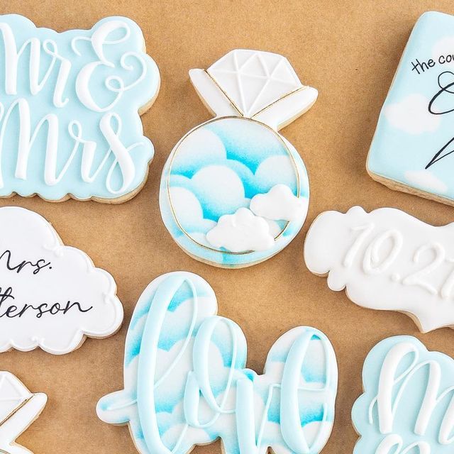 Wedding-Themed Decorative Cookies: Romantic Light Blue, White, and Whimsical Cloud Designs.