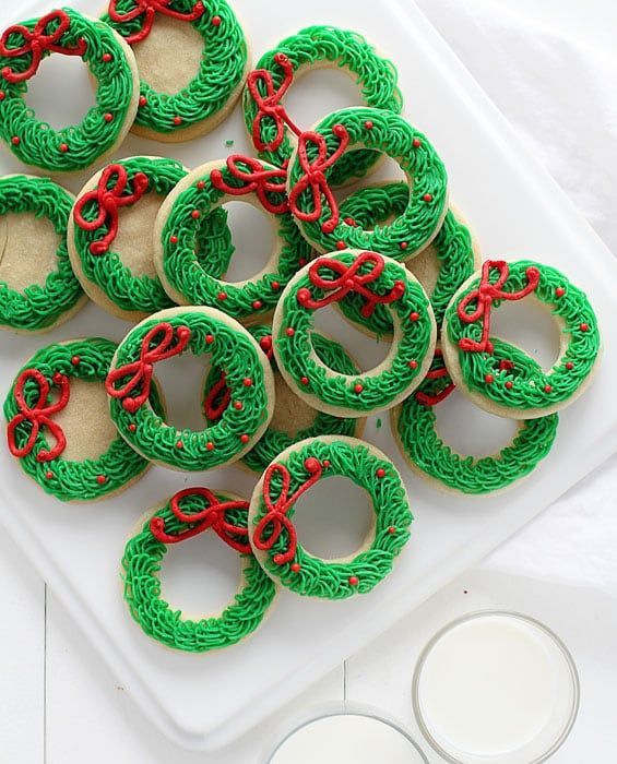 Festive Wreath Cookies: Colorful Holiday Treats with Evergreen Icing and Charming Bow Details.