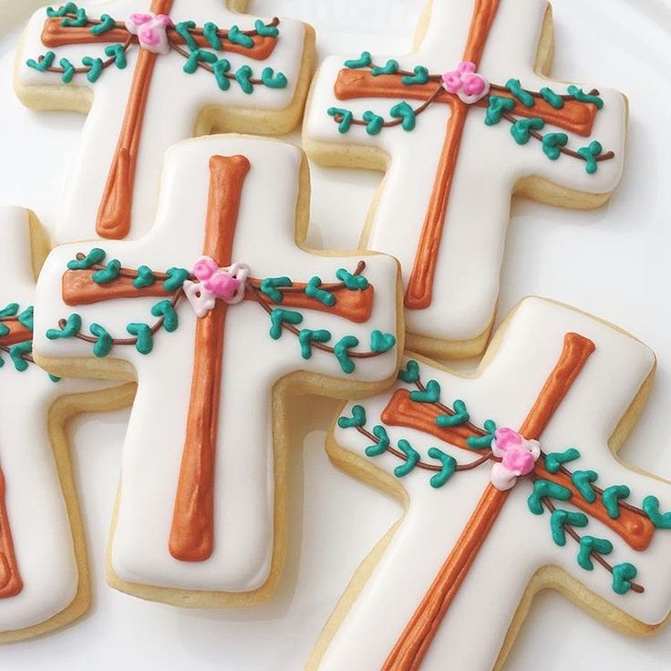 Elegant Cross-Shaped Cookies: White Icing with Green Vines and Pink Flowers for Celebrations