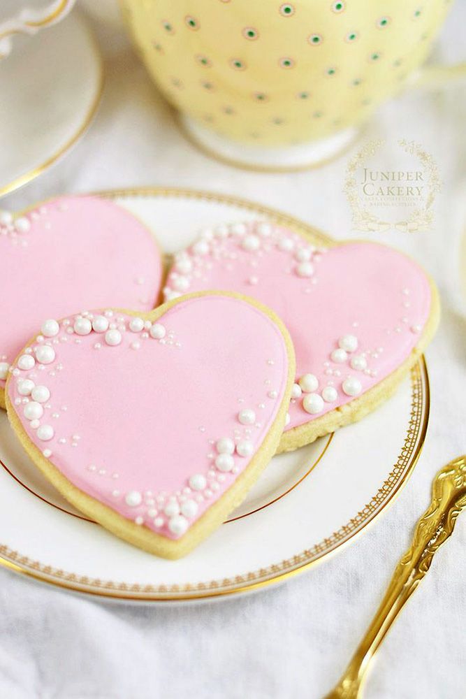 Charming Heart-Shaped Cookies with Elegant Pink Icing and Pearl Accents.