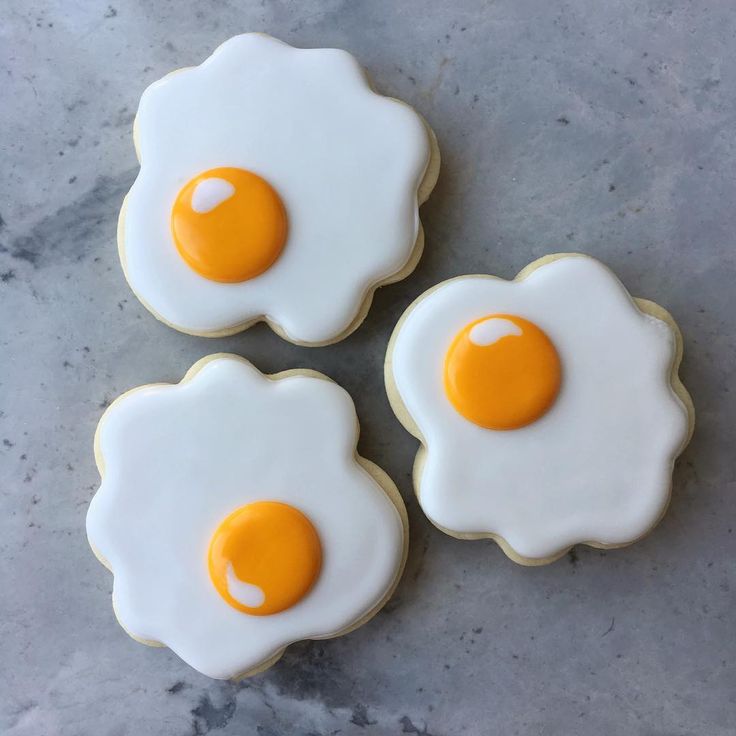 Whimsical Egg-Inspired Cookies with Icing and Vibrant Yolk Centers.