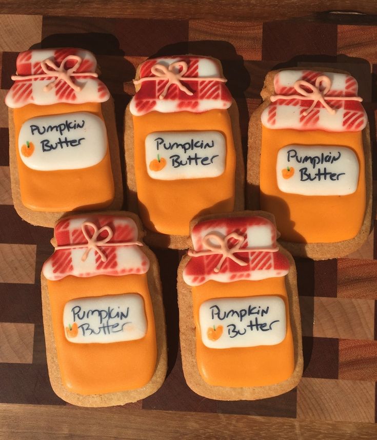 Autumn-themed Decorative Cookies Mimicking Pumpkin Butter Jars with Vibrant Icing.