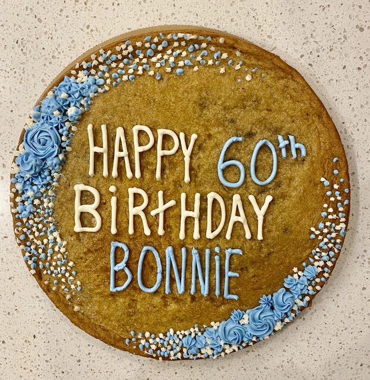 Festive Cookie Cake Embellished with Blue Icing Flowers and White Decorations.