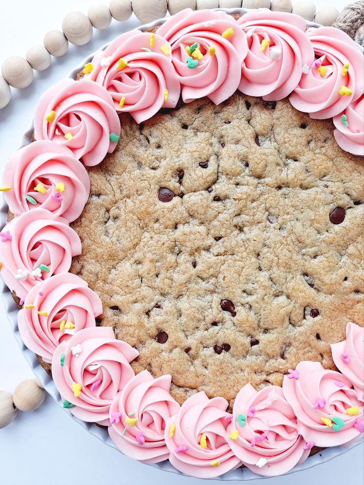 Delightful Chocolate Chip Cookie Cake with Pink Frosting and Sprinkles.