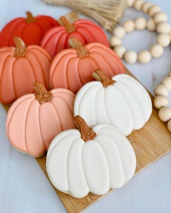 Festively Decorated Colorful Pumpkin Cookies on a Wooden Platter