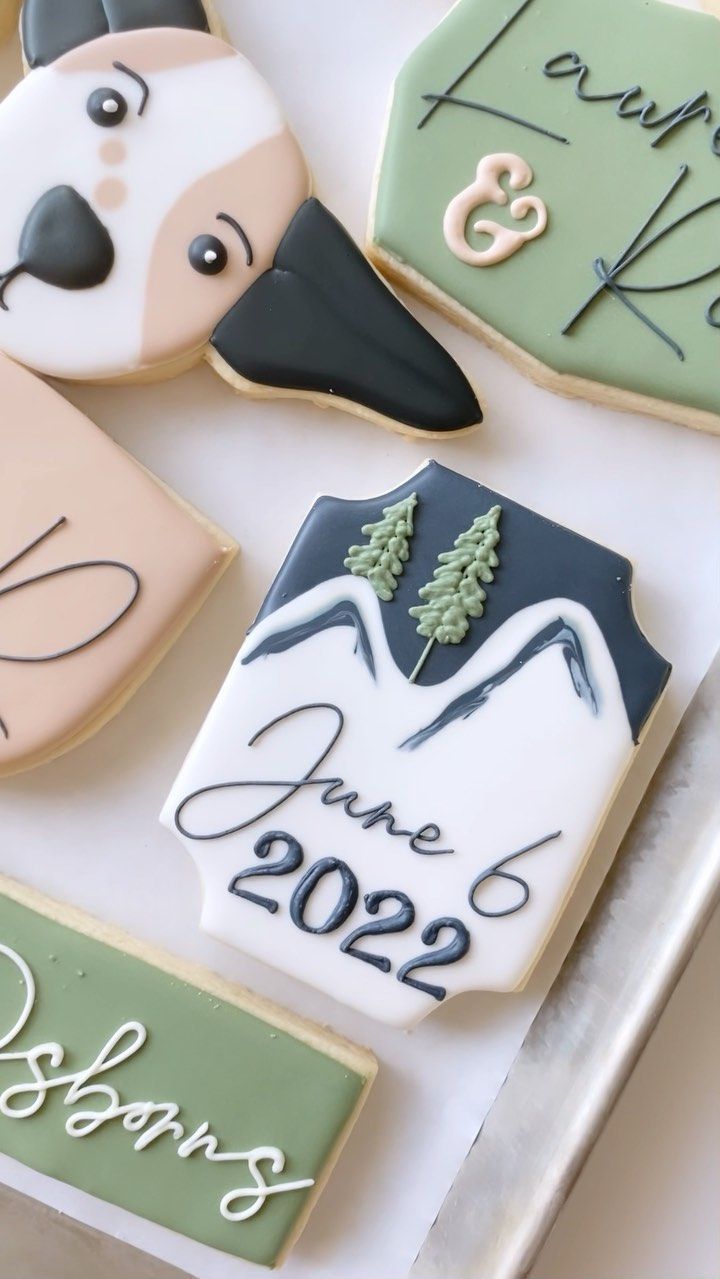 Whimsical Decorative Cookies: Playful Dog Faces and Mountainous Scenes for Celebrations.