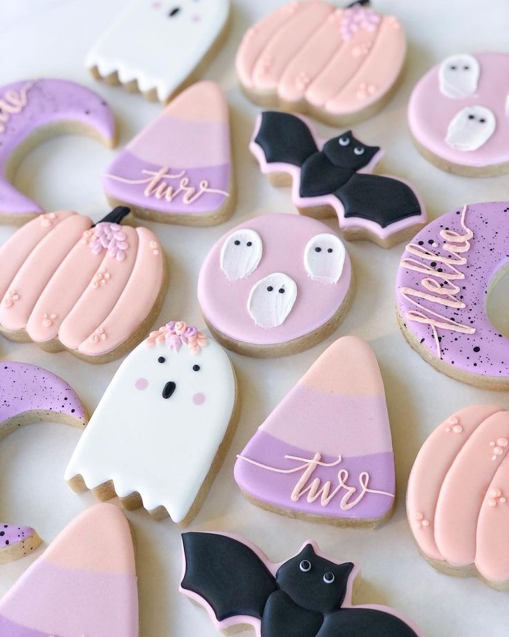 Whimsical Halloween-Themed Colorful Cookie Designs Featuring Adorable Ghosts, Bats, and Pumpkins.