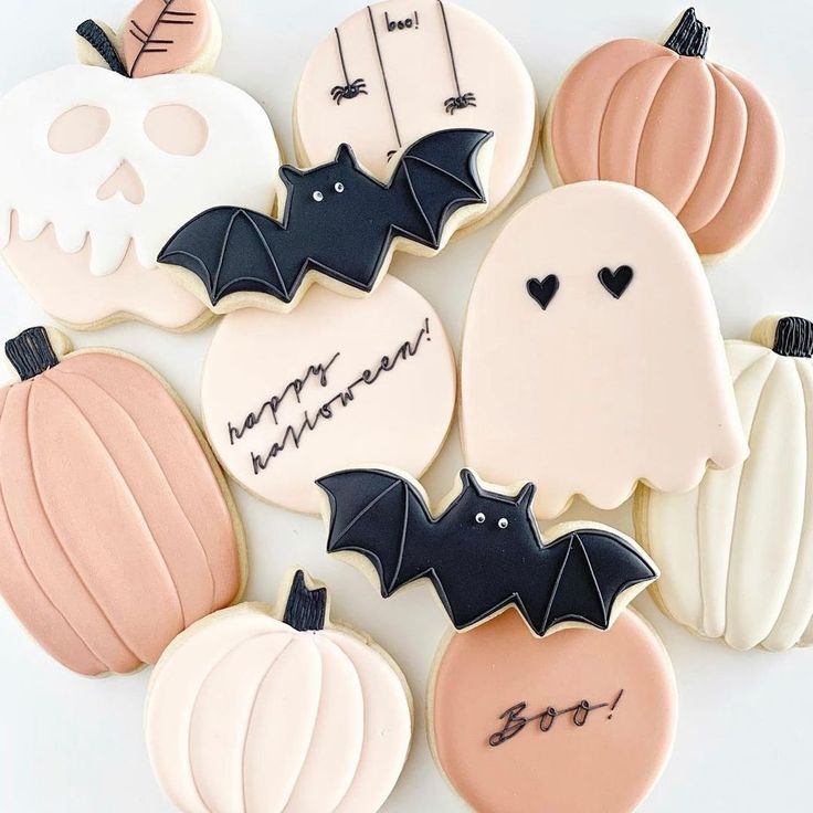 Festive Halloween Cookies: Whimsical Designs in Soft Pastels and Bold Black Accents.