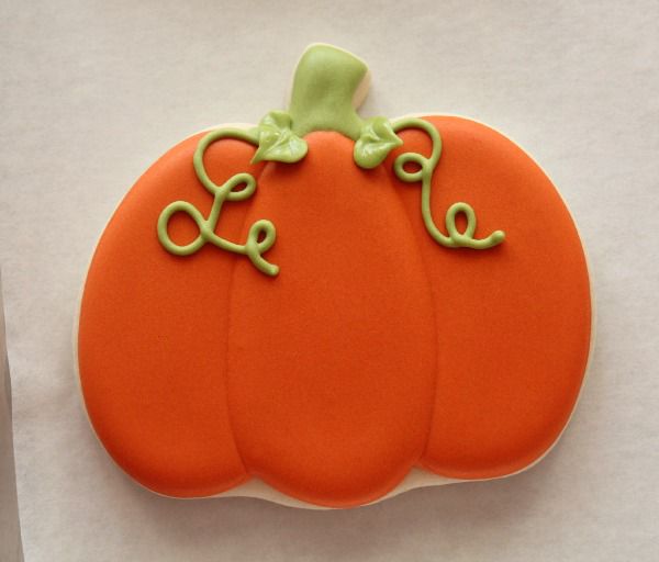 Whimsical Pumpkin-Shaped Cookie with Vibrant Colors Perfect for Fall Celebrations.