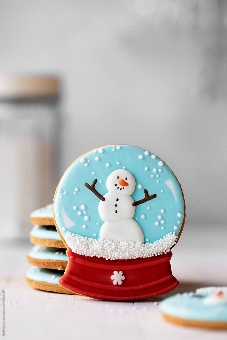 Charming Snow Globe Cookie Design: Festive Snowman with Snowflakes and Vibrant Colors for Whimsical Nail Art.