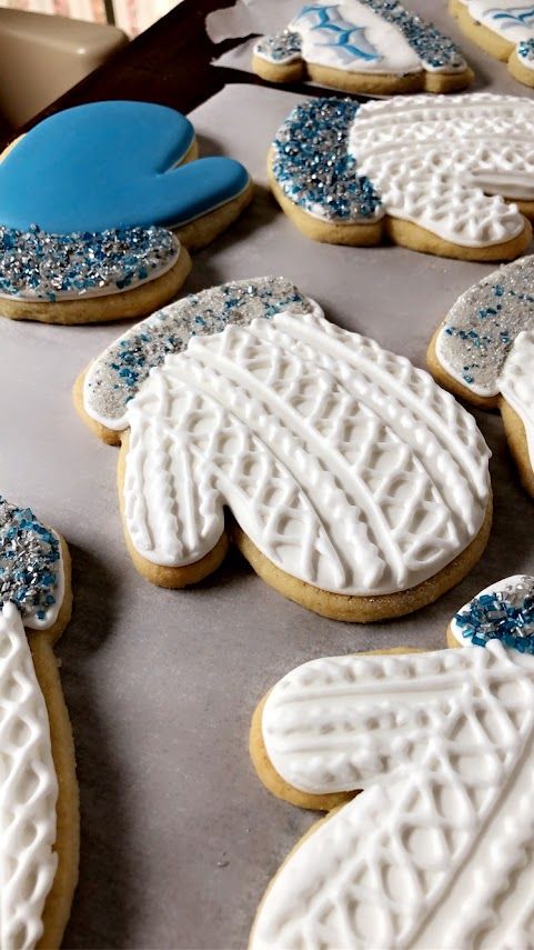 Whimsical Winter Mitten Cookies: Festive Designs with Delicate Icing and Colorful Accents.