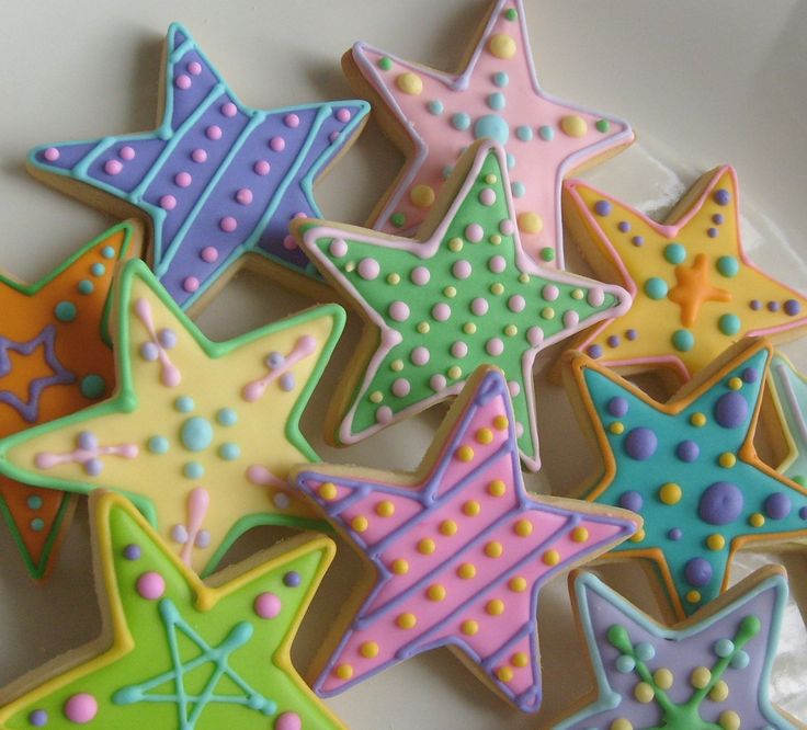 Whimsical Star-Shaped Cookies Inspire Fun and Creative Nail Designs with Vibrant Pastel Icing Patterns.