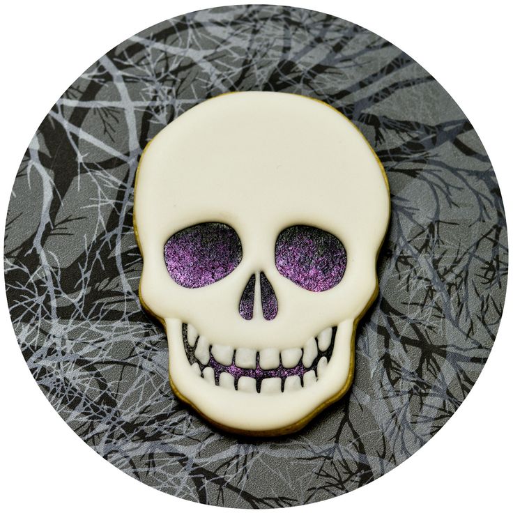 Stylish Skull-Themed Nail Design with Glossy Purple Finish for Halloween and Alternative Styles.