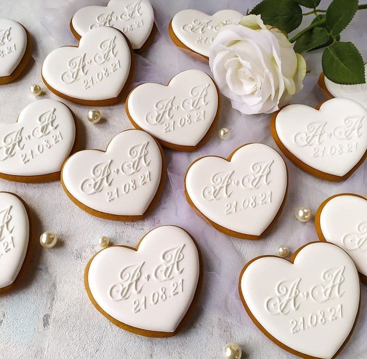 Elegant Heart-Shaped Cookies with White Icing and Sophisticated Gold Accents in a Romantic Arrangement.