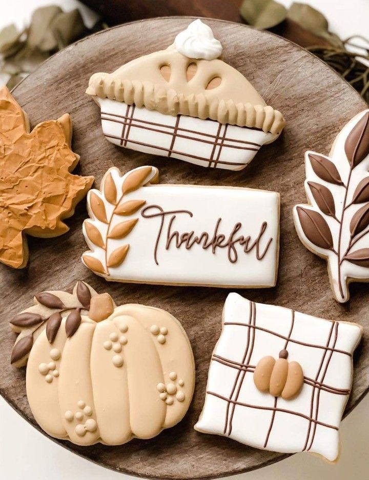 Autumn-Themed Decorative Cookies Displayed on a Wooden Platter