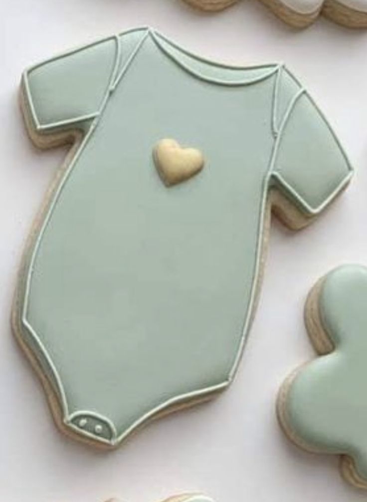 Charming Baby Onesie Cookie Design in Muted Green with Sweet Yellow Heart for Celebrations.