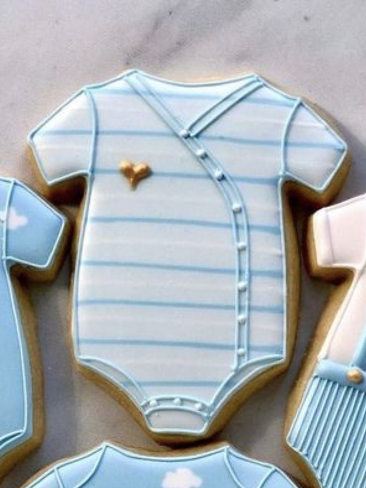 Charming Baby Onesie-Inspired Sugar Cookies with Heart Motif, Ideal for Showers and Celebrations.