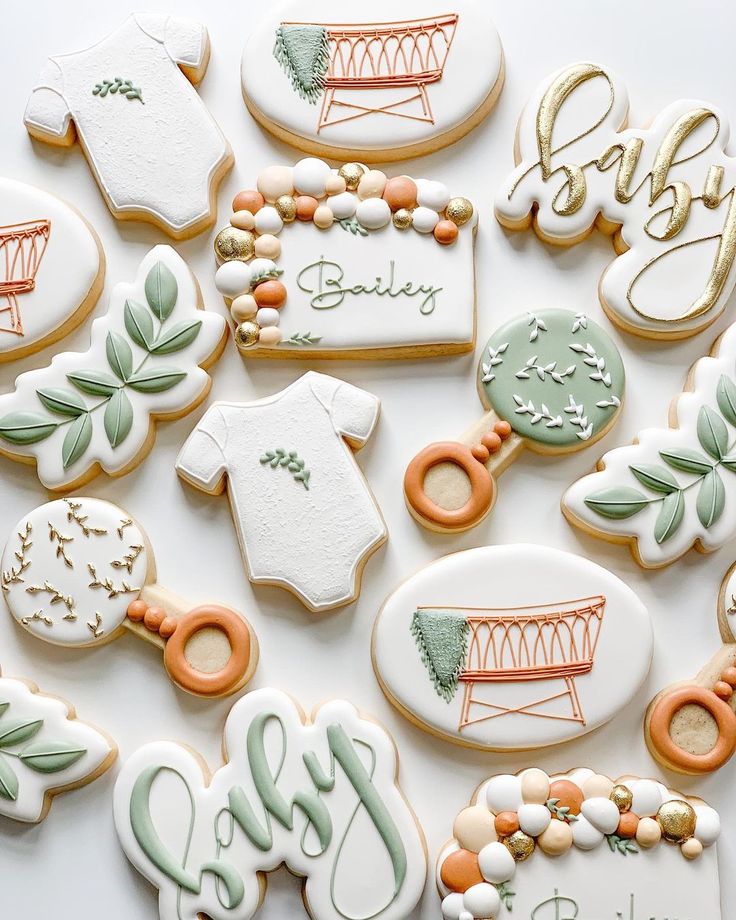 Charming Pastel Baby Celebration Cookies adorned with Onesies, Cribs, and Floral Designs.