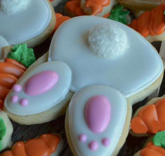 Playful Bunny Foot Cookies with Glossy Icing and Vibrant Carrot Treats for Spring Celebrations