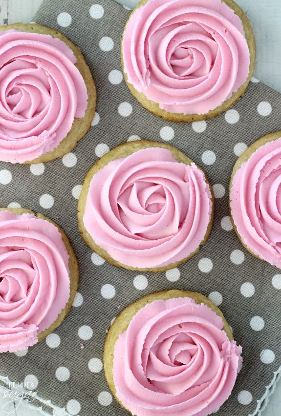 Elegant Round Cookies Topped with Whimsical Rose-Shaped Pink Frosting