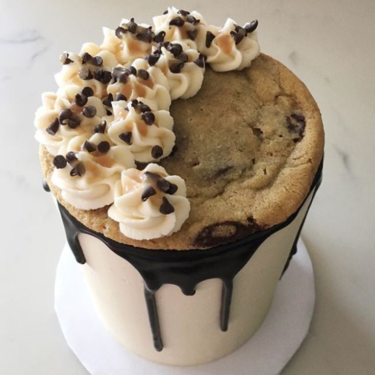 Decadent Round Cookie Cake with Frosting, Chocolate Chips, and Dripping Chocolate.