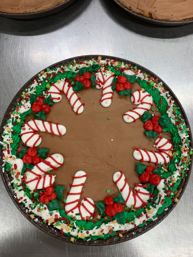 Delightful Chocolate Festive Cake Adorned with Candy Canes, Roses, and Green Icing.