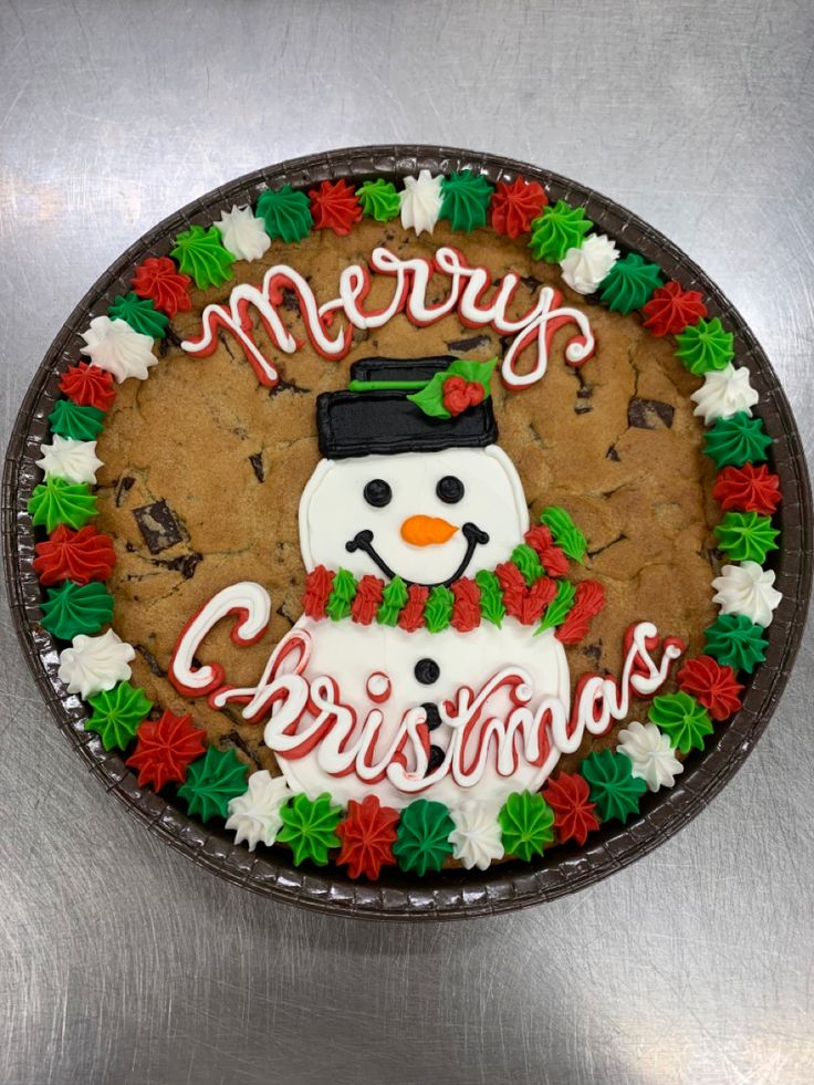 Cheerful Holiday Cookie Cake Adorned with a Smiling Snowman and Vibrant Icing