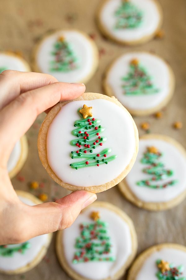 Intricately Iced Festive Christmas Cookies: Delightful Green Trees Adorned with Red and Gold.