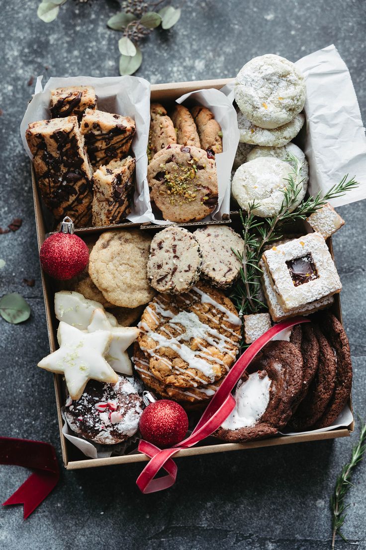 Holiday Gift Box Brimming with Assorted Baked Goods and Festive Decorations.