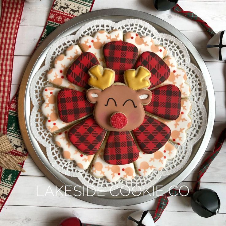 Festive Decorative Cookie Platter with Playful Reindeer Centerpiece and Plaid Snowflake Surroundings.