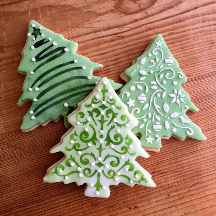 Elegant Holiday Tree Cookies with Intricate Green Designs and Unique Embellishments