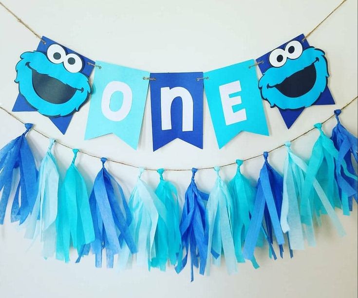 Vibrant Party Decor: Cheerful Blue & Turquoise Banners with Playful Characters and Fluffy Streamers.