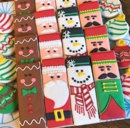 Festive Decorative Cookies: Whimsical Gingerbread Men, Snowmen, and Santa Claus Delight with Colorful Icing.