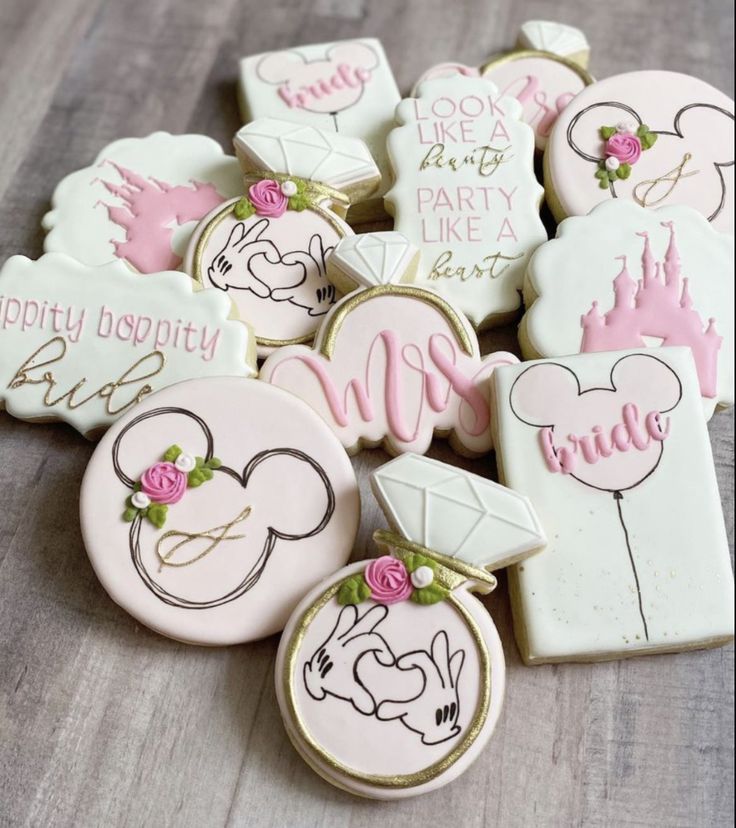 Charming Whimsical Cookie Designs: Mickey Mouse and Diamond Rings in Pastel Floral Accents for Celebrations.