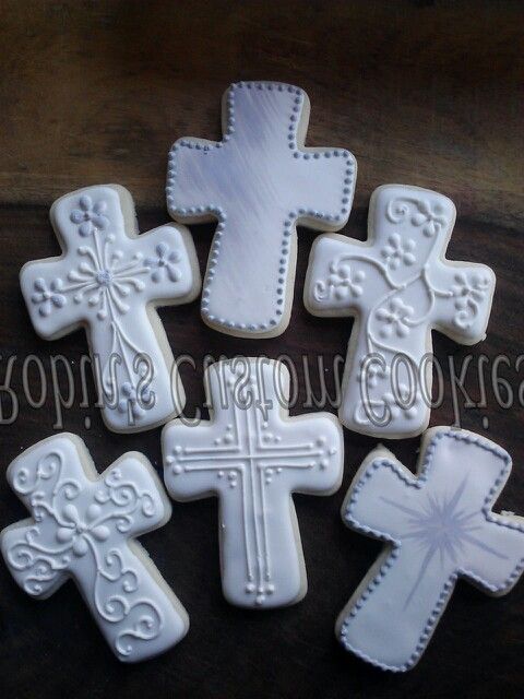 Intricately Iced Cross-Shaped Cookies: Elegantly Designed for Special Occasions.