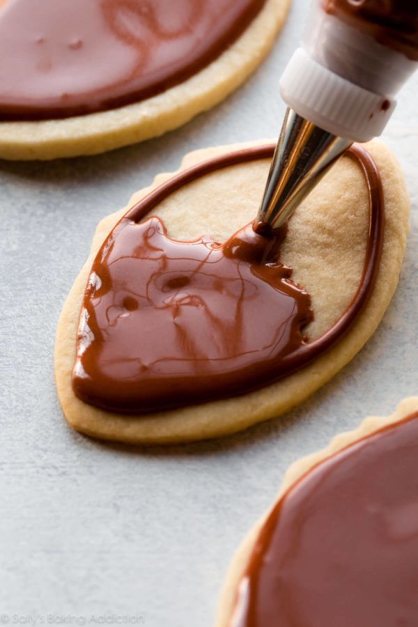 Artfully Decorated Cookies with Smooth Chocolate Frosting and Intricate Piping Details