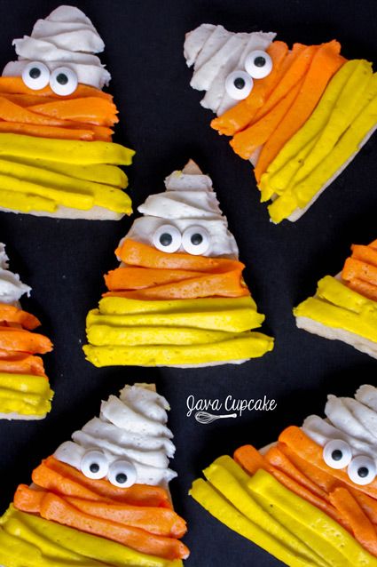 Whimsical Candy Corn-Shaped Treats with Colorful Icing for Festive Gatherings.