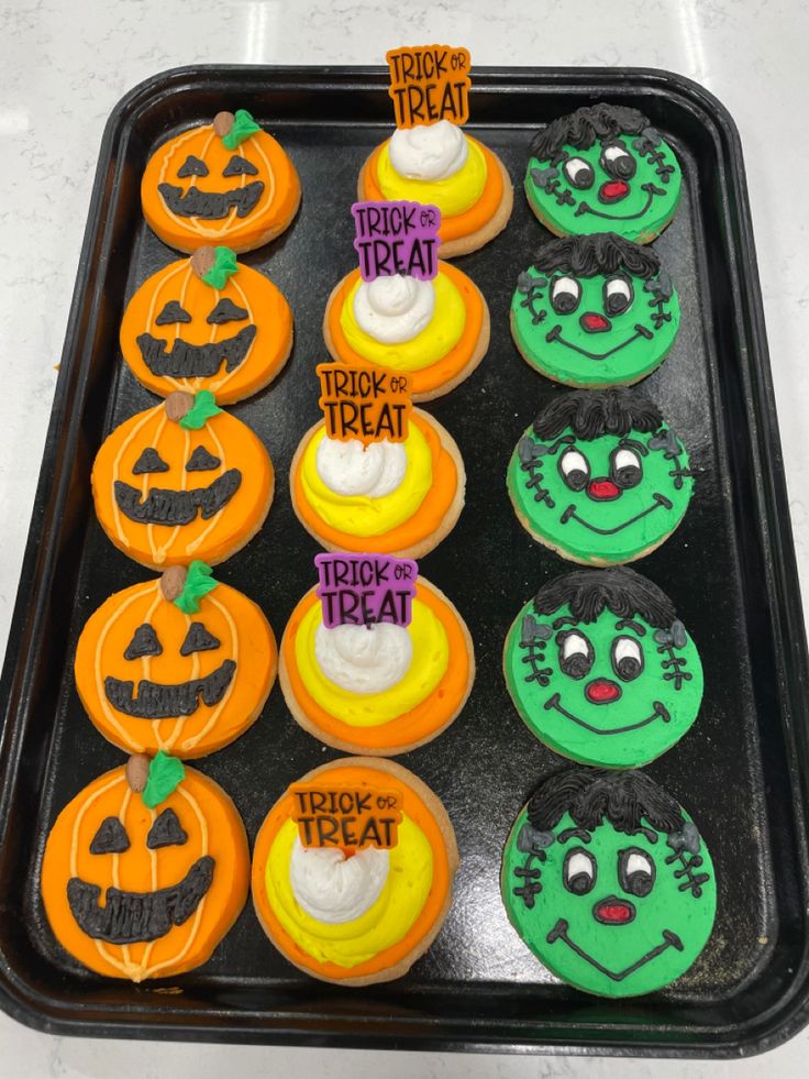 Creative Arrangement of Colorful Halloween-Themed Cookies with Whimsical Designs and Festive Toppings.