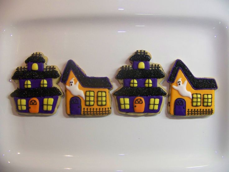 Halloween-Inspired Colorful Cookies with Haunted House Designs and Spooky Nail Art Ideas.